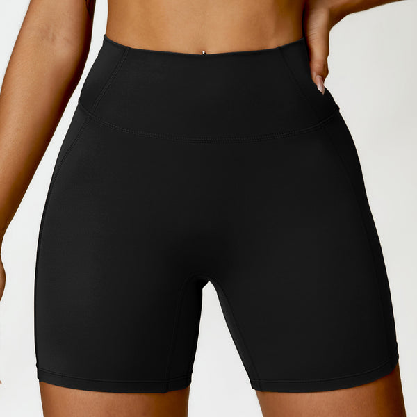 Black athletic shorts worn by a person on a white background
