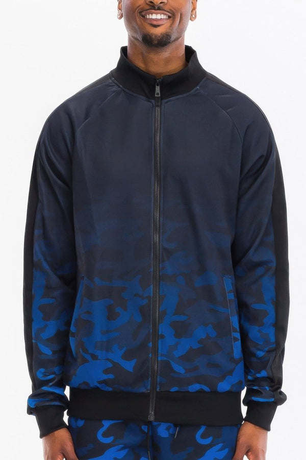 Man wearing a black and blue camouflage jacket on a white background