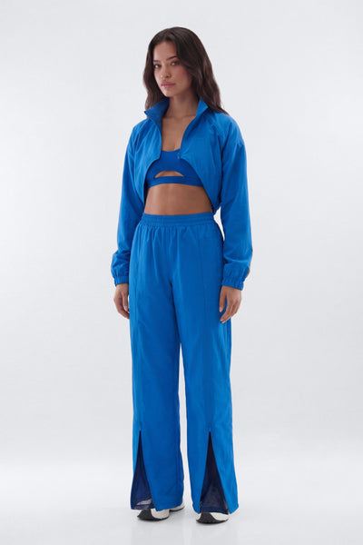 Woman wearing a blue tracksuit on a white background