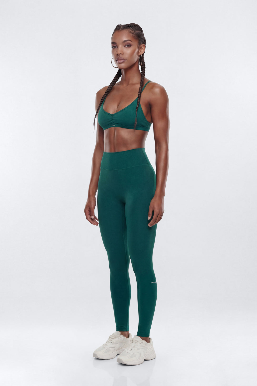 Woman wearing a green athletic outfit on a white background