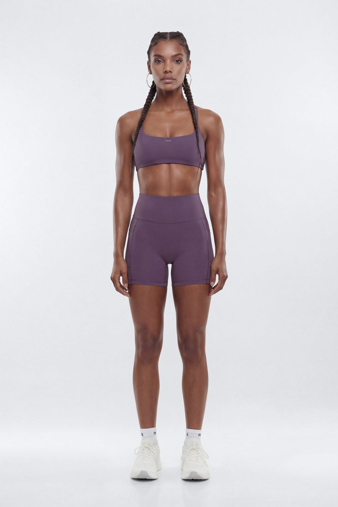 Person wearing a purple athletic outfit on a white background