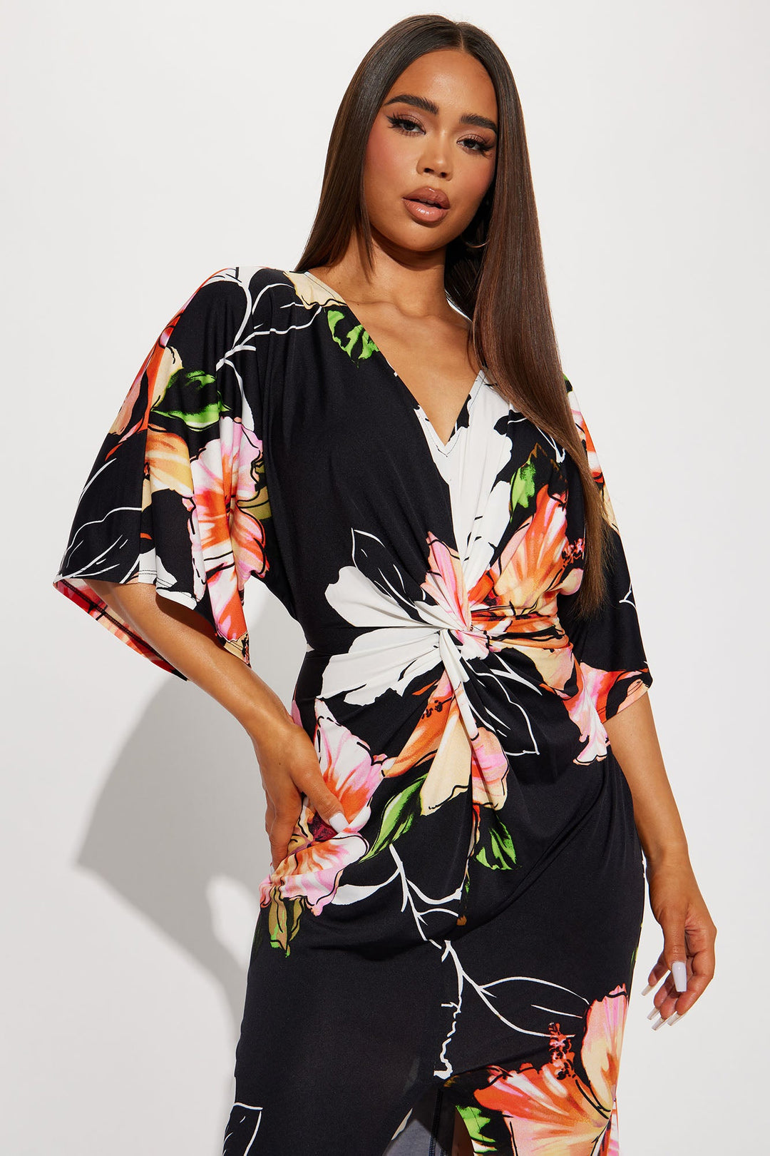 Woman wearing a black floral dress against a white background