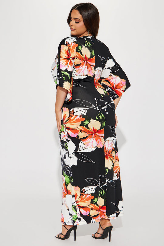 Woman wearing a black floral dress on a white background