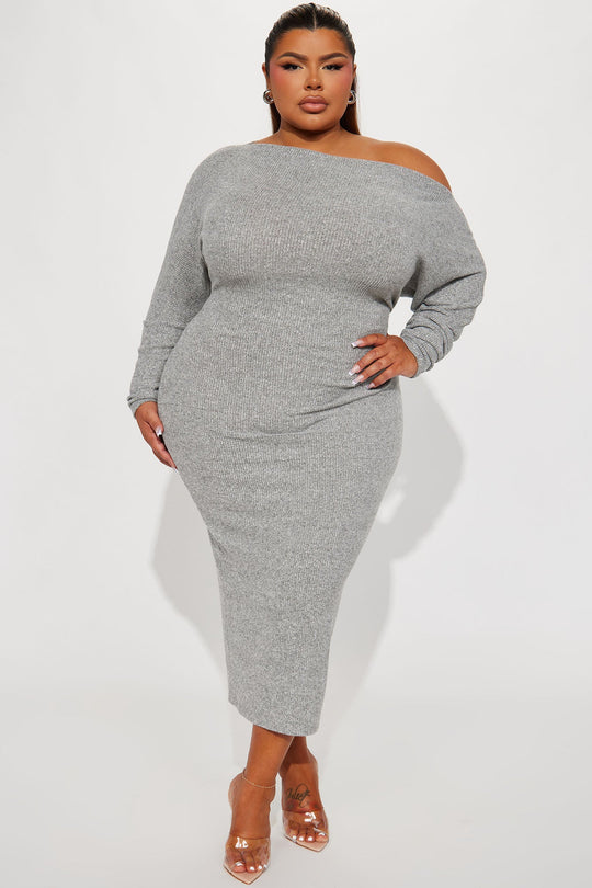 Woman wearing a gray off-shoulder dress on a white background