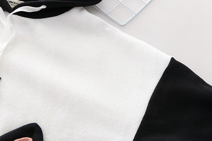 Front view of the Women’s Oversized Hoodie, featuring a spacious pocket and drawstring hood, ideal for added comfort.