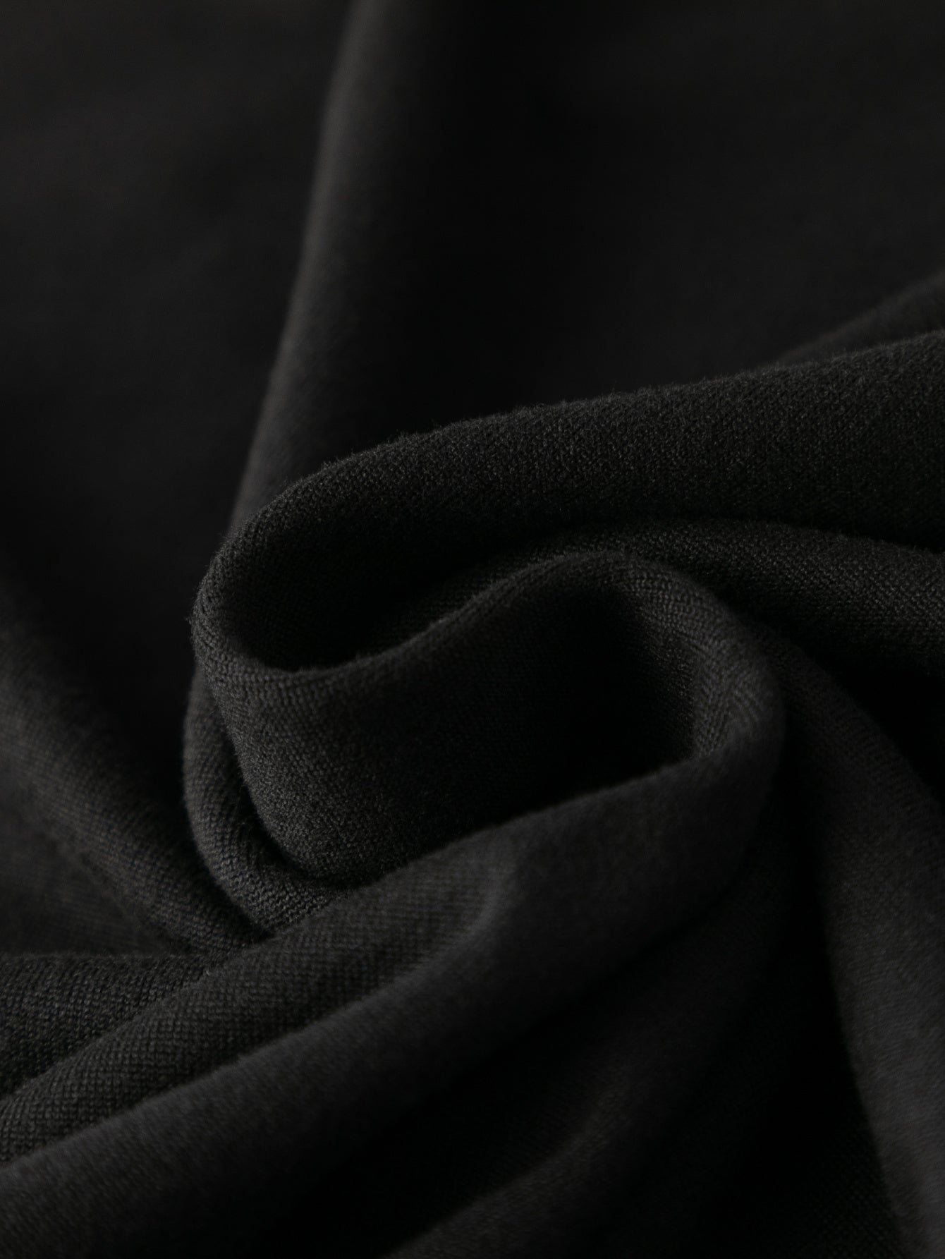 Side view of the Women's Y2K Jamaica Graphic Print Crop Tank Top Black, emphasizing the sleeveless design and stretchable fabric.