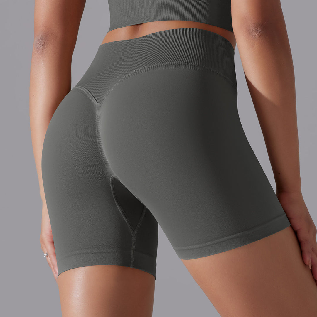 Dark gray athletic shorts worn by a person on a gray background