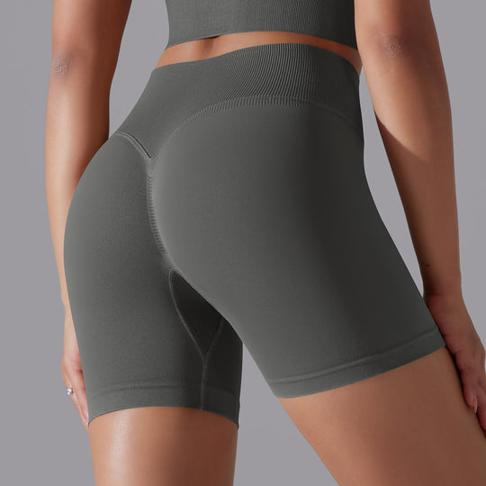 Dark gray athletic shorts worn by a person on a gray background