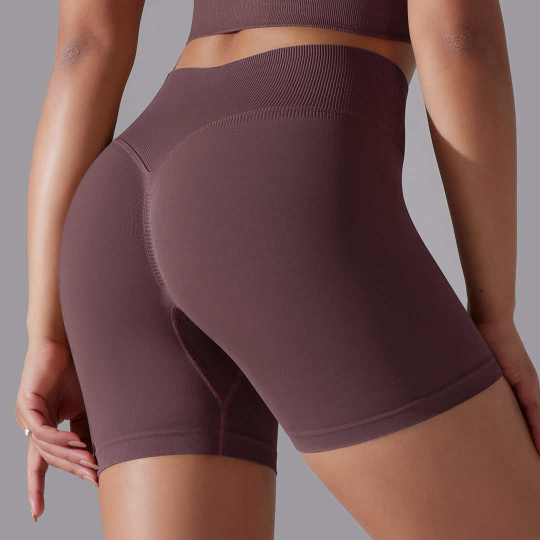Maroon athletic shorts worn by a person on a gray background
