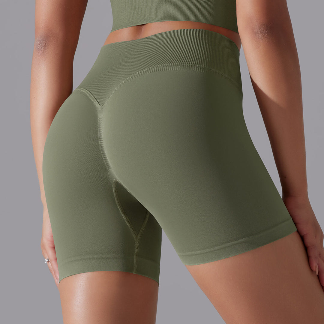 Green athletic shorts worn by a person on a gray background