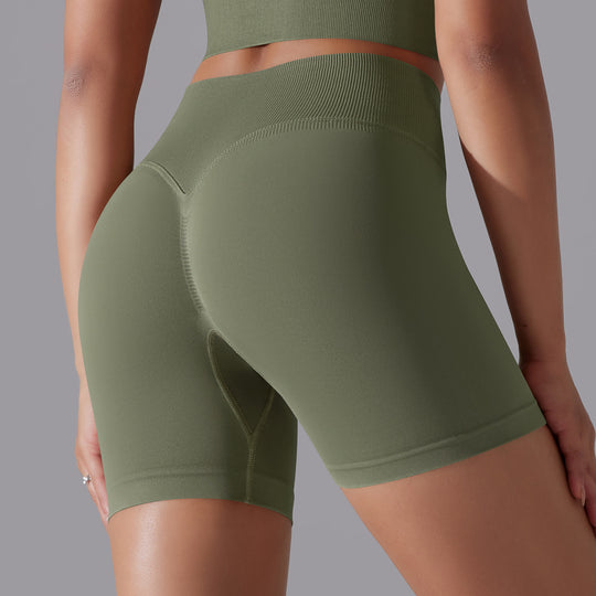 Green athletic shorts worn by a person on a gray background