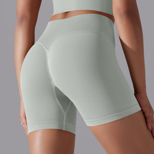 Light green athletic shorts worn by a person on a gray background