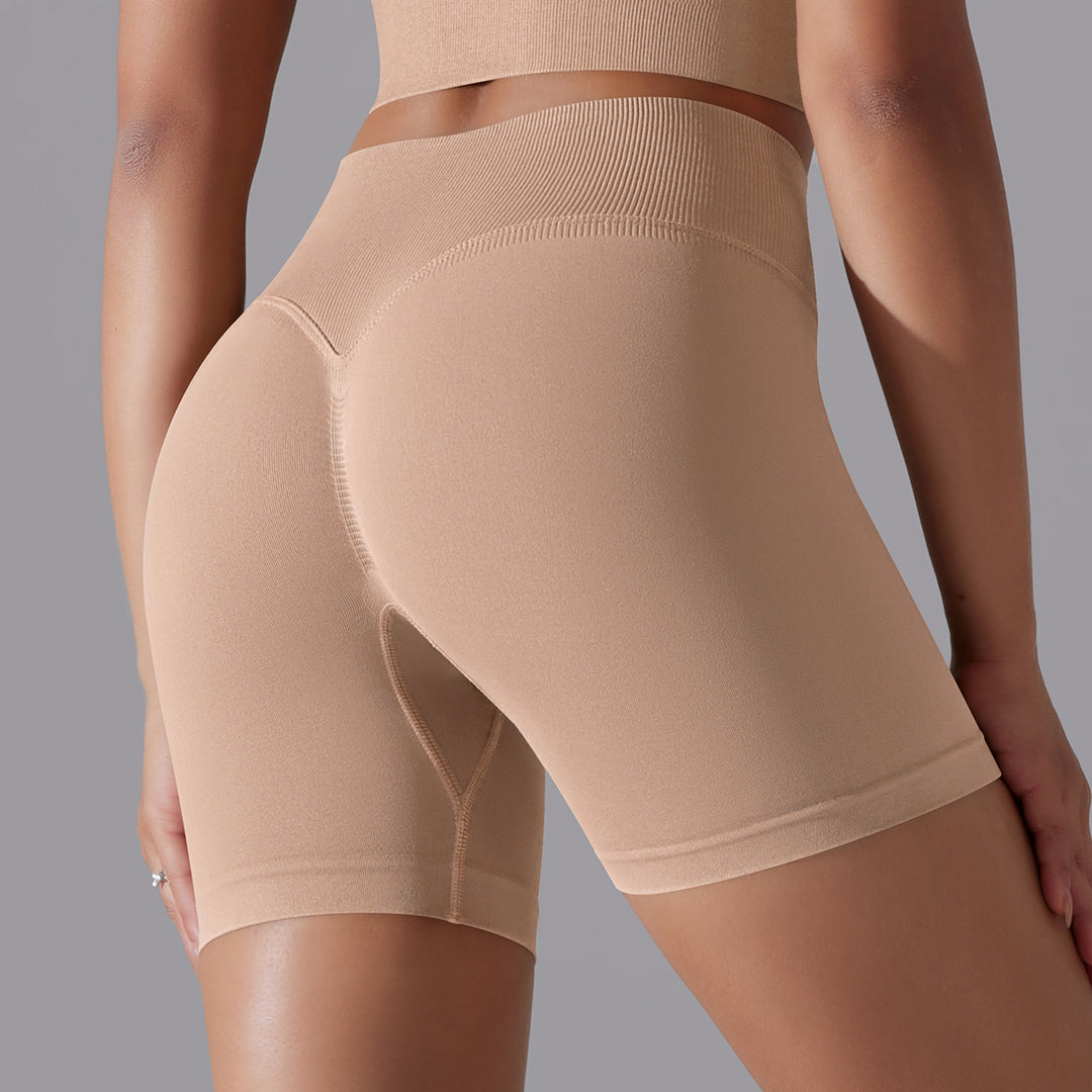 Beige shapewear shorts worn by a person on a gray background