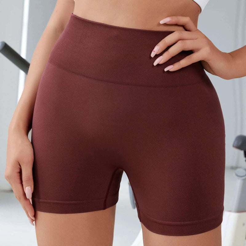 Brown high-waisted shorts worn by a person in an indoor setting