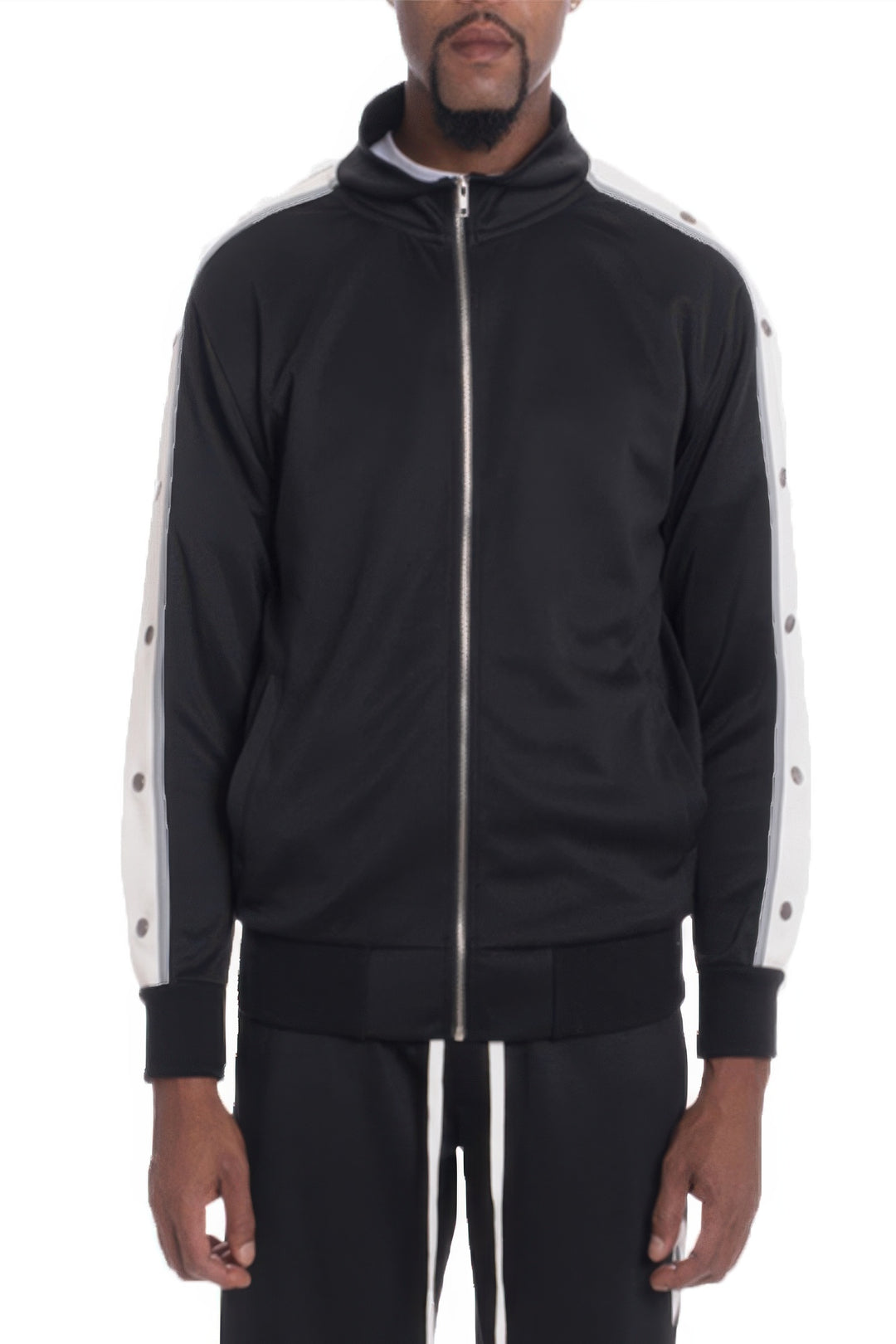 Black tracksuit with white stripes on sleeves and sides, worn by a person on a white background