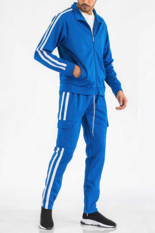 Person wearing a blue tracksuit with white stripes on a white background