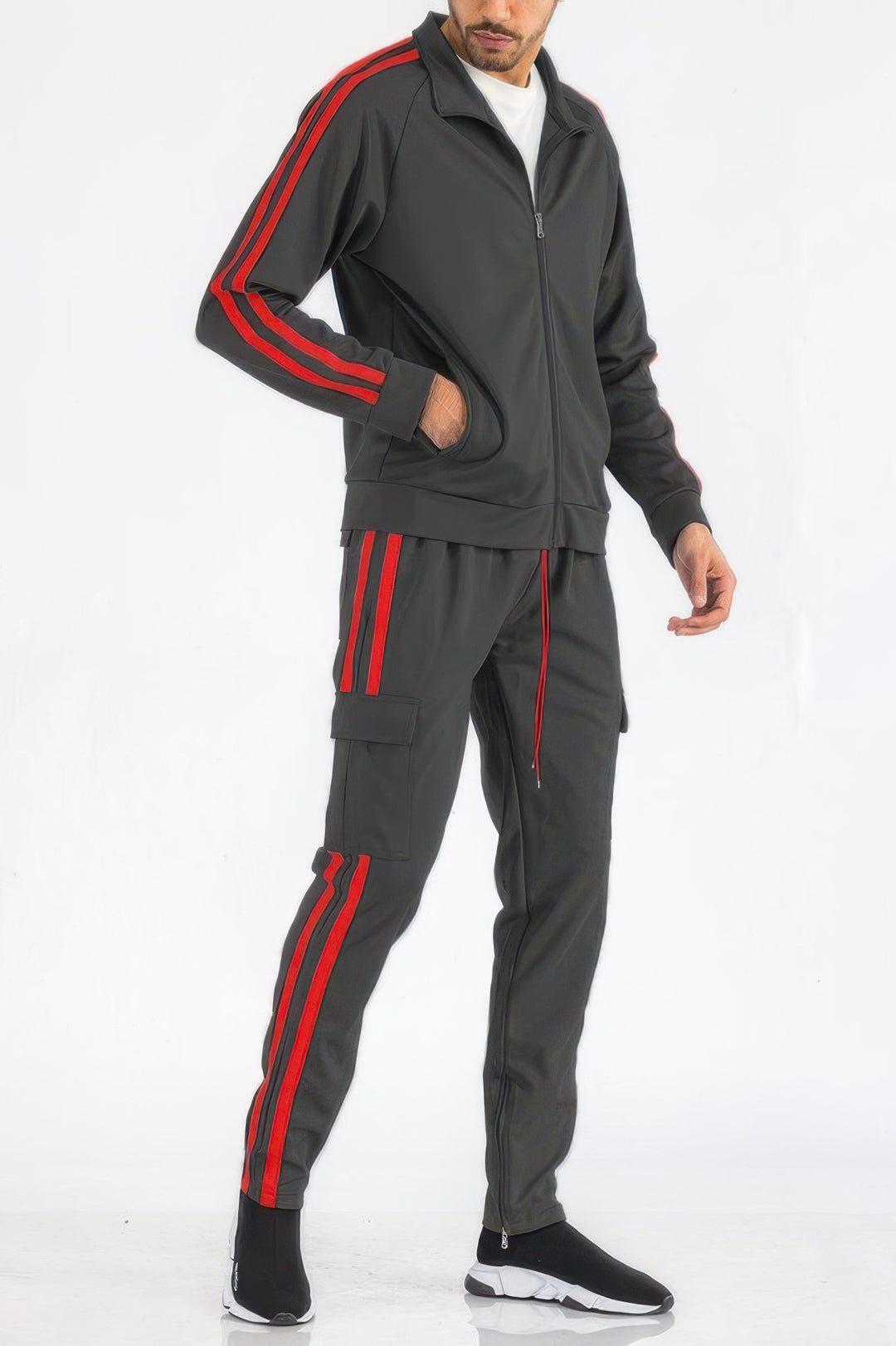 Man wearing a gray tracksuit with red stripes on a white background