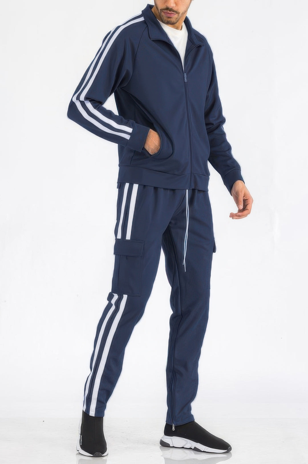 Person wearing a navy tracksuit with white stripes on a white background