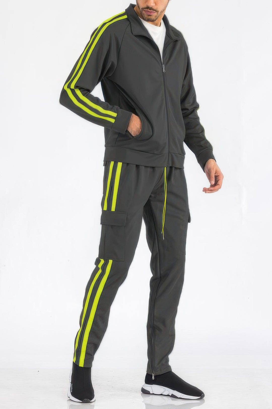 Man wearing a gray tracksuit with yellow stripes on a white background