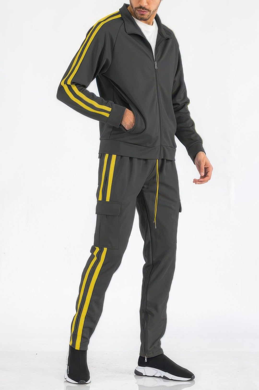 Man wearing a gray tracksuit with yellow stripes on a white background
