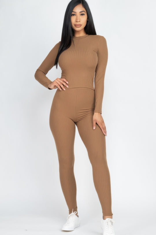 Woman wearing a brown ribbed outfit on a white background
