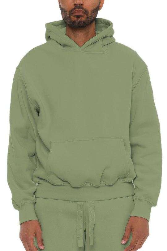 Person wearing a green hoodie on a white background