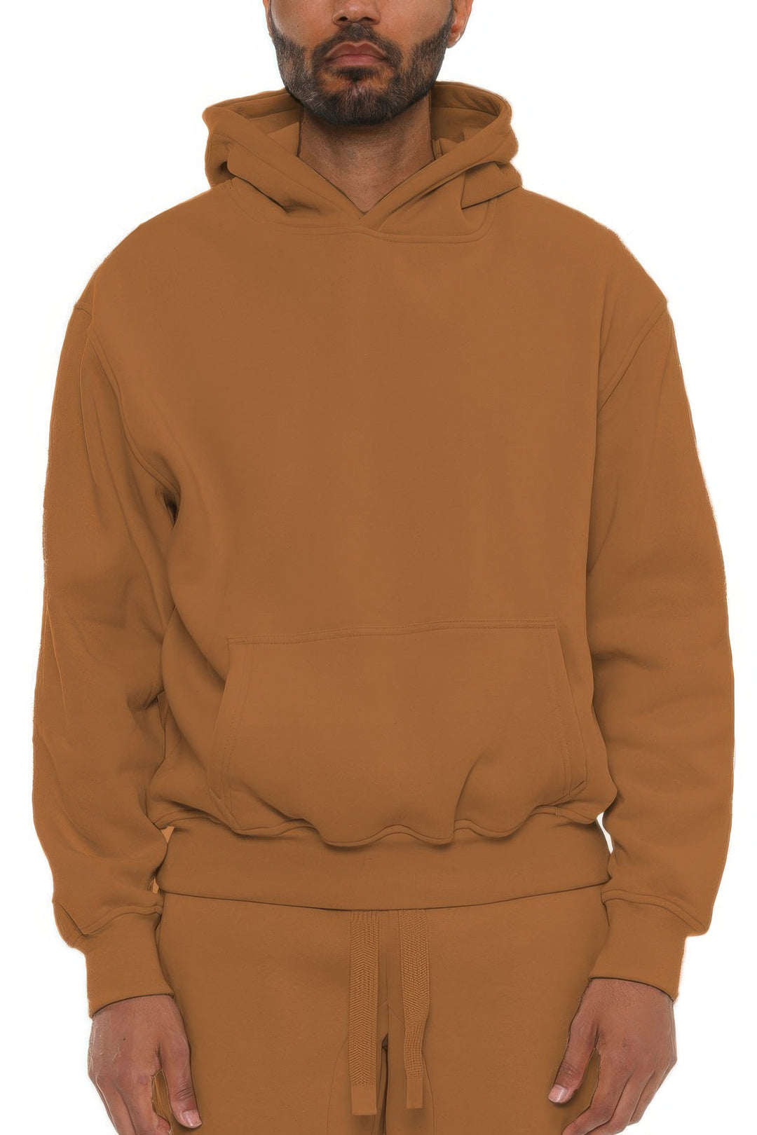 Man wearing a brown hoodie and pants on a white background