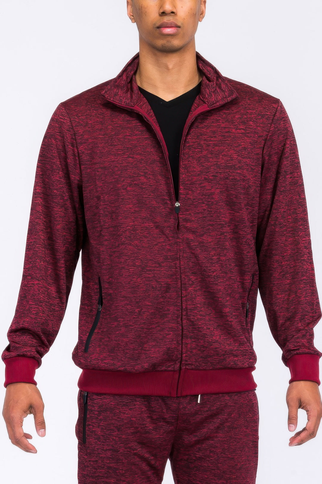 Maroon tracksuit worn by a person on a white background