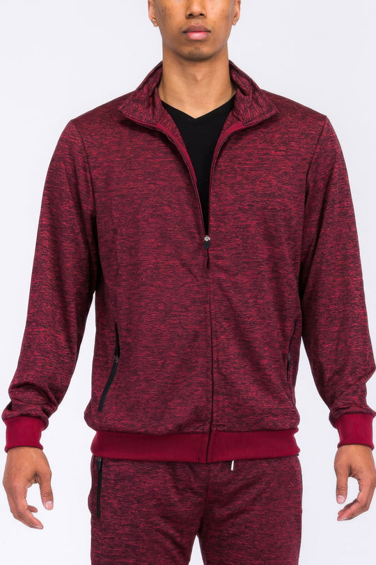 Maroon tracksuit worn by a person on a white background