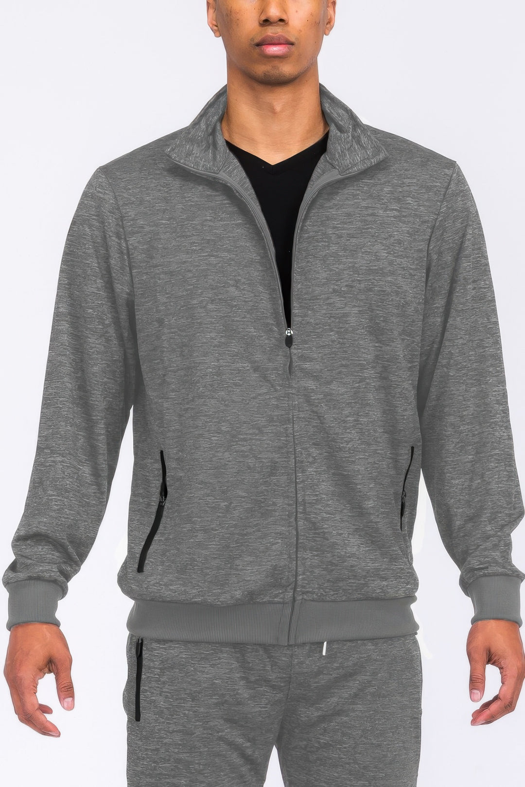 Person wearing a gray tracksuit on a white background