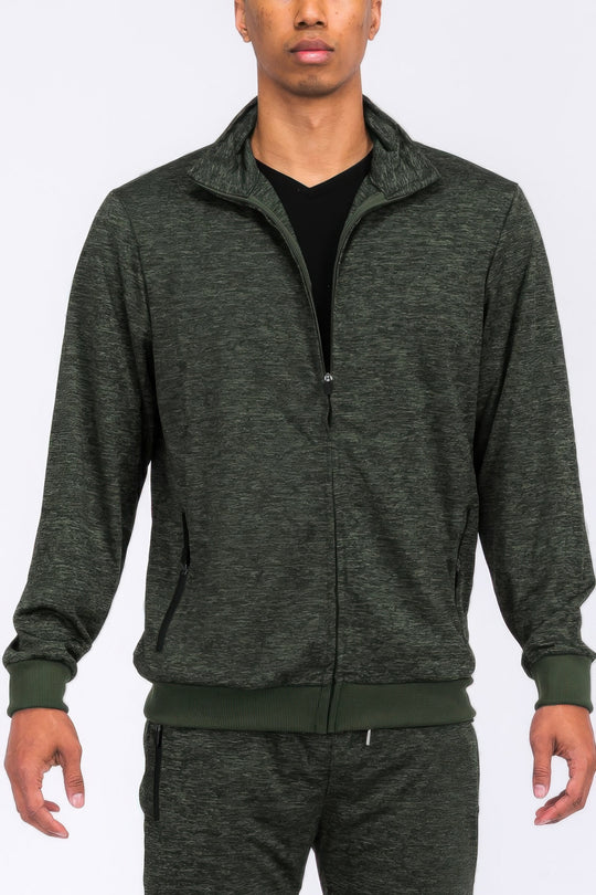 Person wearing a gray tracksuit on a white background