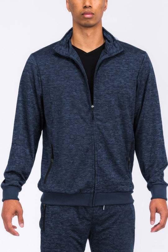 Person wearing a navy blue tracksuit on a white background