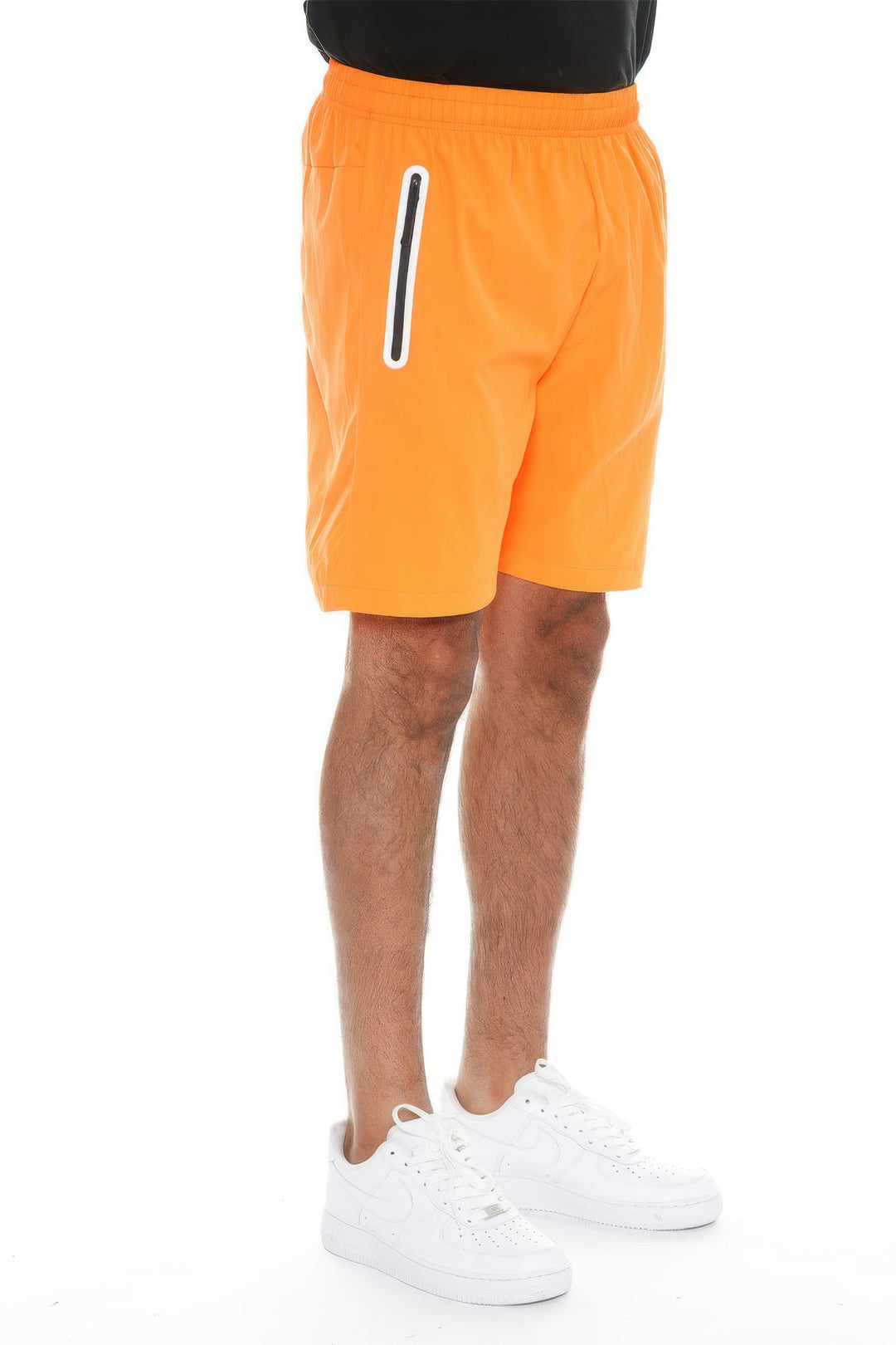 Person wearing bright orange shorts with a white stripe on a white background