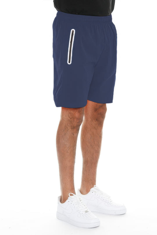 Person wearing navy shorts with a white stripe on a white background