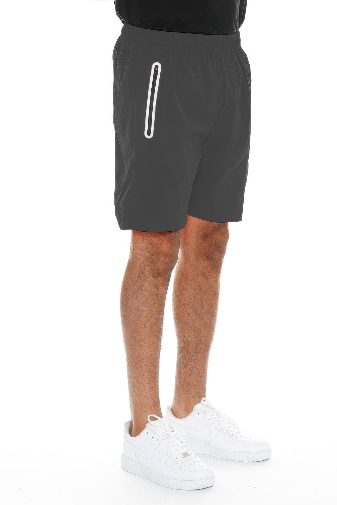 Person wearing dark gray shorts with a white stripe on a white background