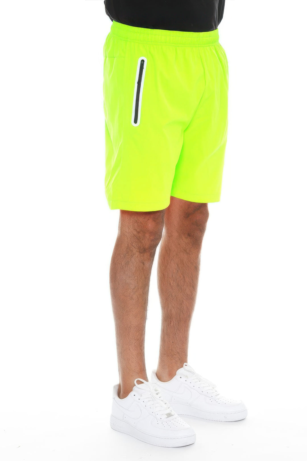 Person wearing bright yellow shorts with a white stripe on a white background