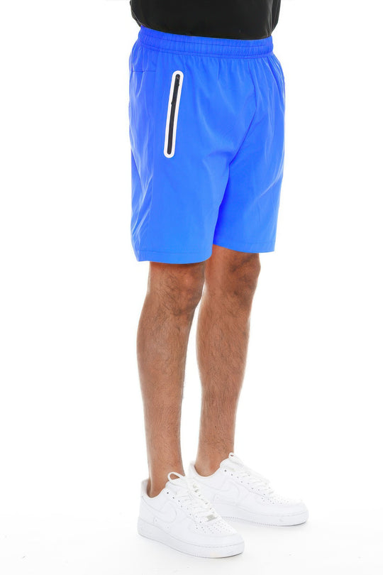 Blue shorts worn by a person on a white background