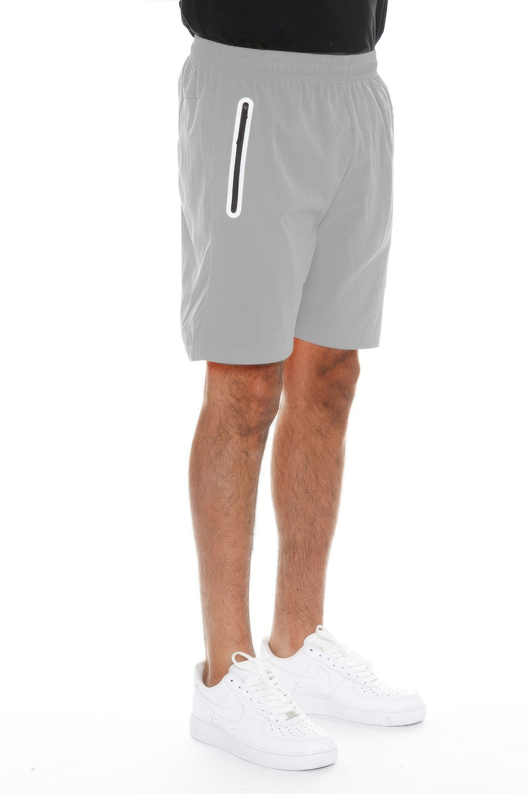 Person wearing gray shorts with a white stripe on a white background