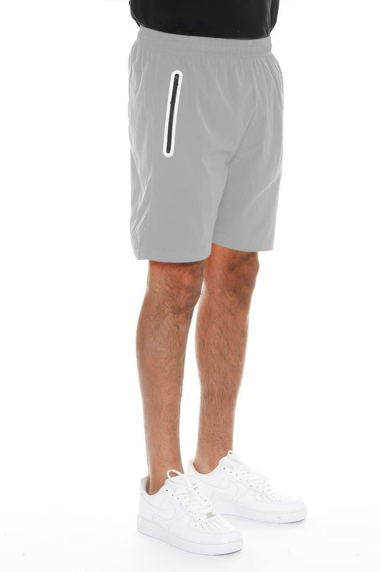 Person wearing gray shorts with a white stripe on a white background