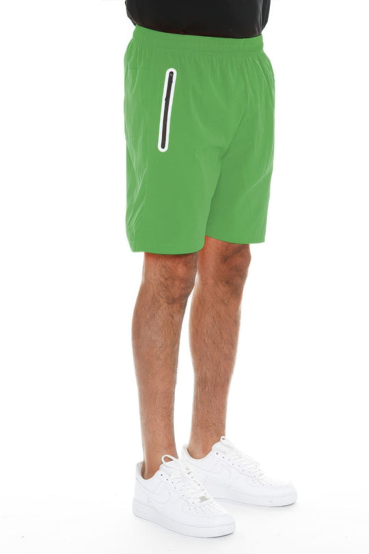 Green shorts worn by a person on a white background