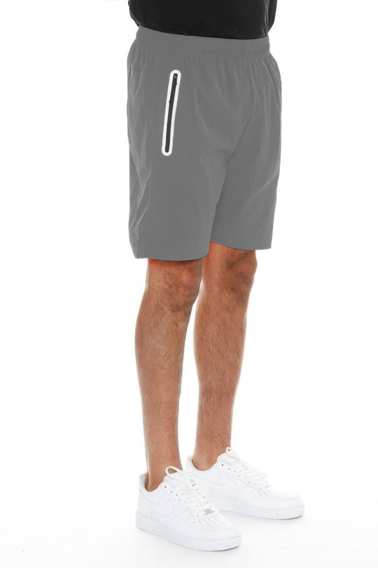 Person wearing gray shorts with a white stripe on a white background