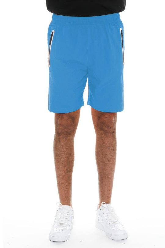 Blue shorts worn by a person on a white background
