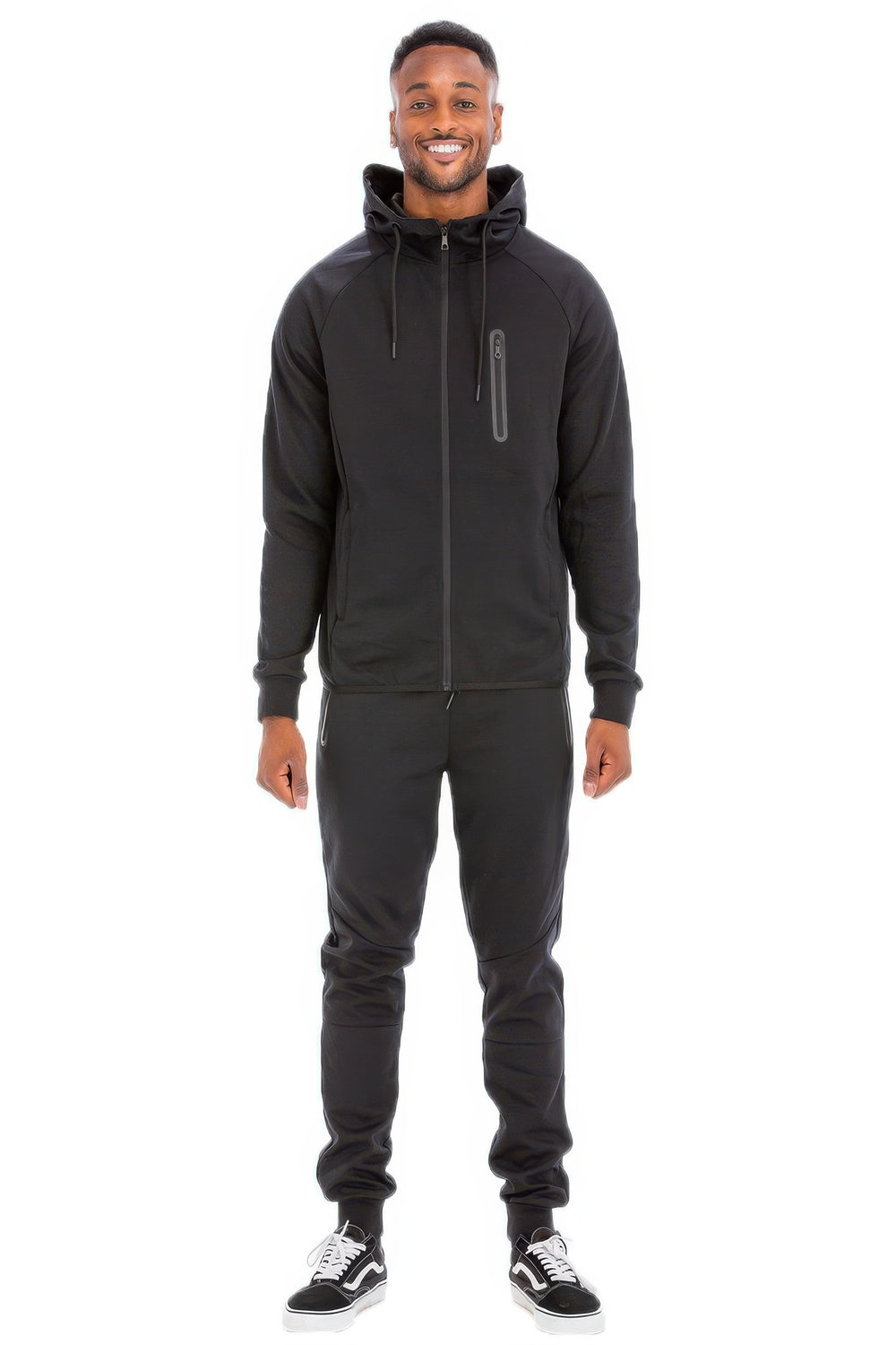 Man wearing a black tracksuit on a white background