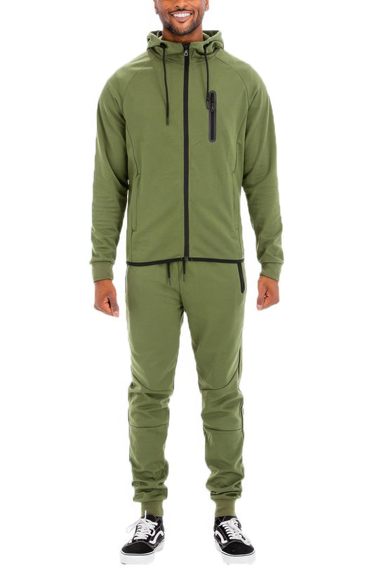 Man wearing a green tracksuit on a white background
