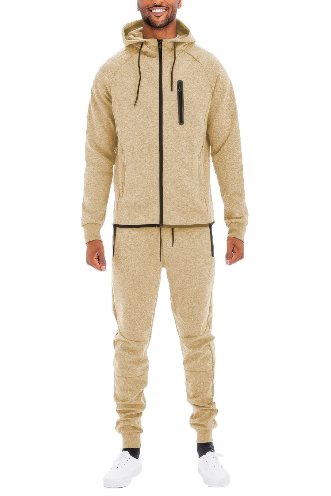Man wearing a beige tracksuit on a white background