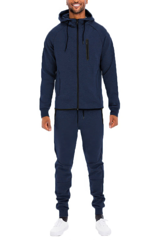 Man wearing a navy blue tracksuit on a white background