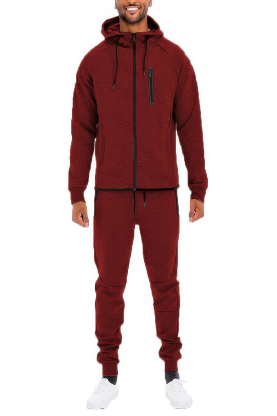 Man wearing a maroon tracksuit on a white background