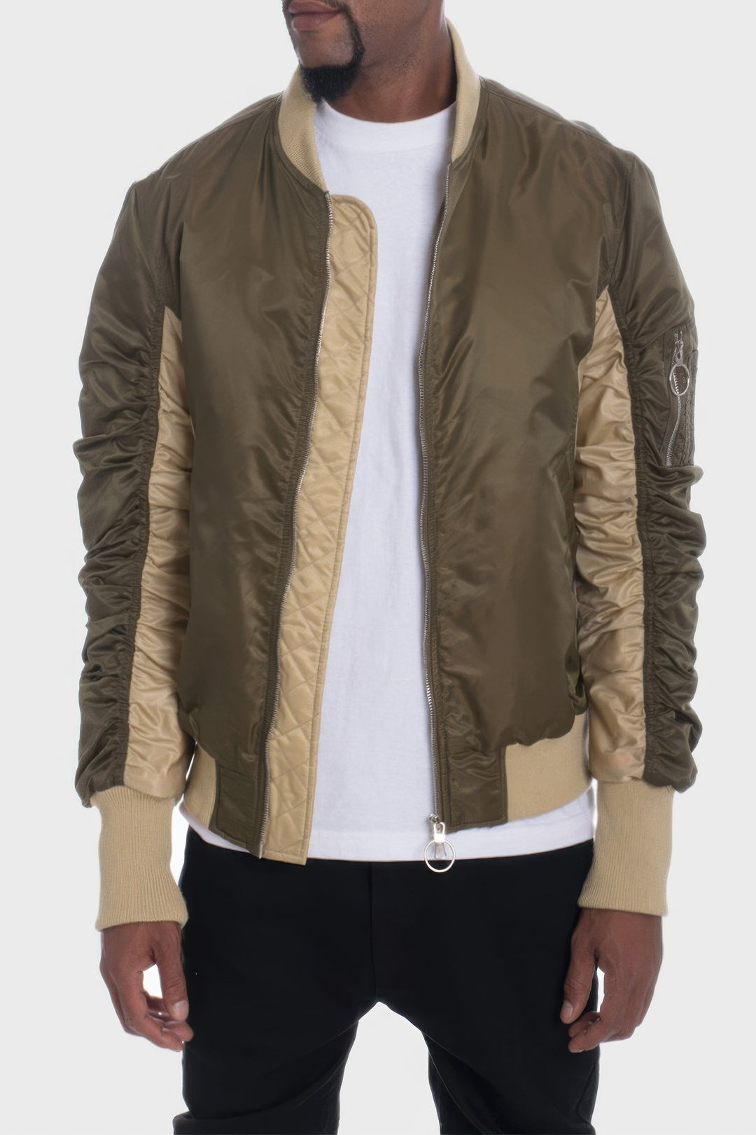 Person wearing a green and beige jacket on a white background