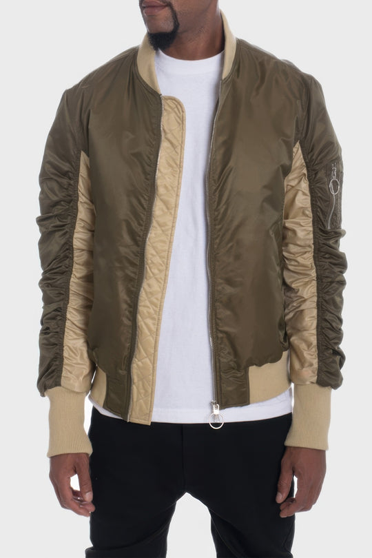Person wearing a green and beige jacket on a white background