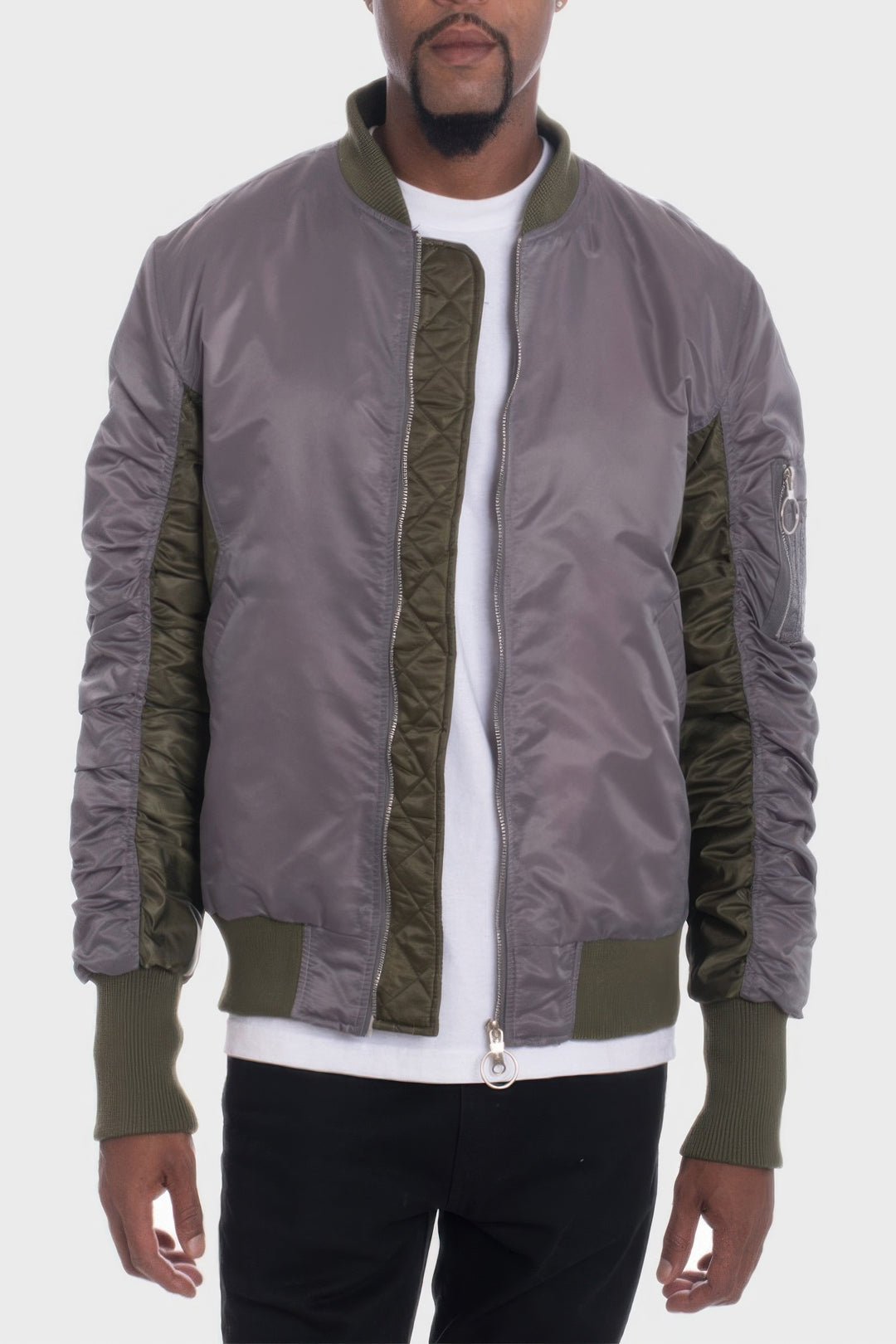 Man wearing a gray and green bomber jacket on a white background